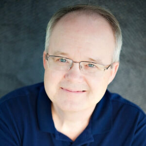 Man smiling with blue shirt