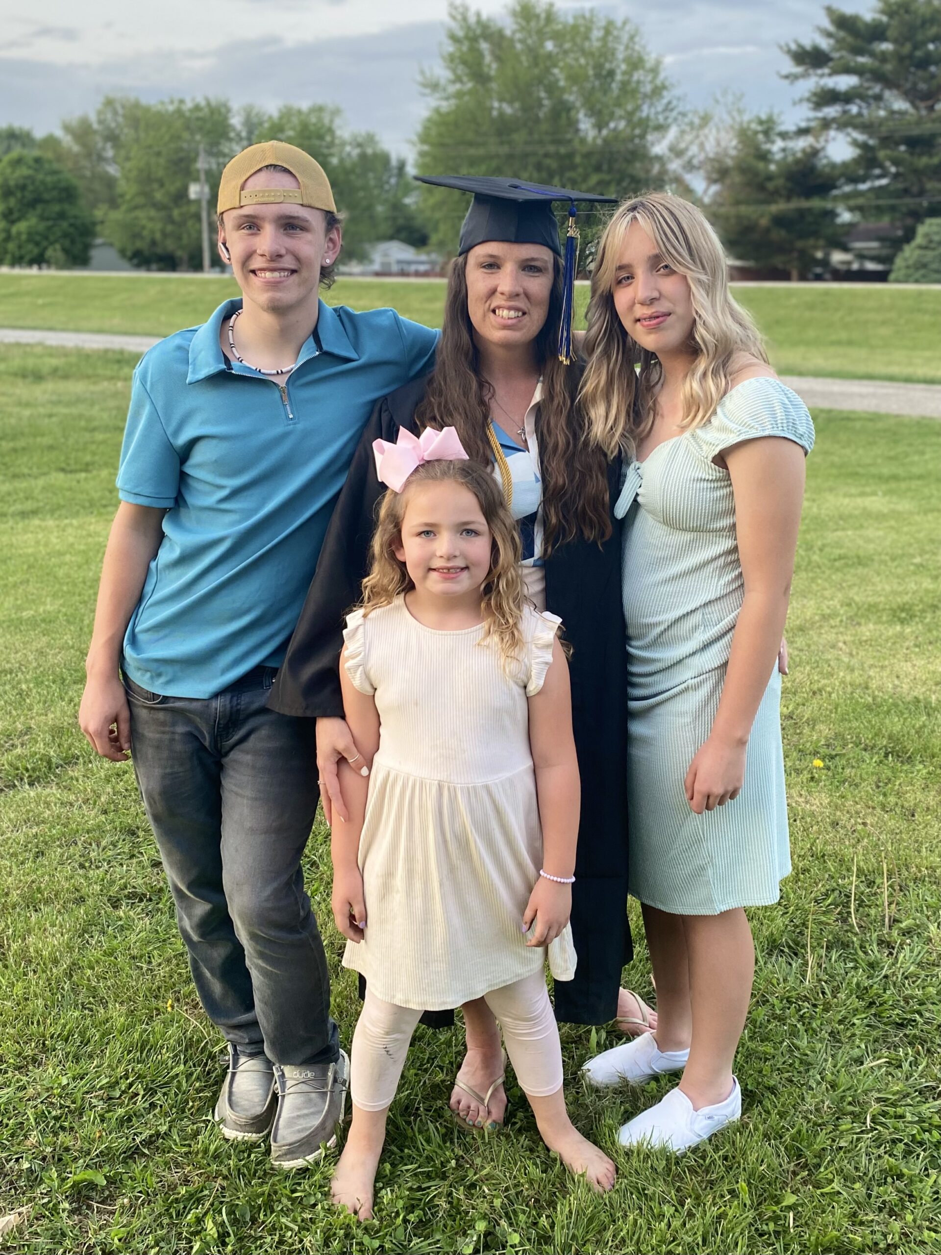 Jenna with her family taking a picture when she graduated