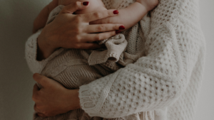 A mother holding a baby in her arms